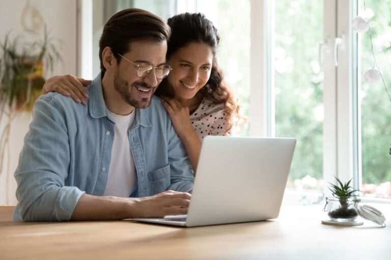 a couple sitting at the computer browsing insurance products